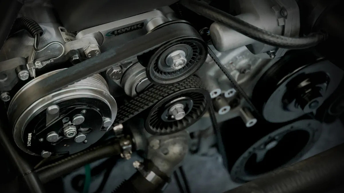 Close-up of a car engine's timing belt and pulleys